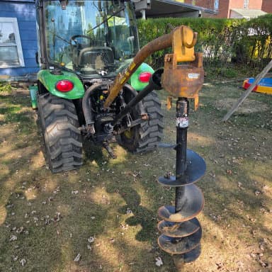 Picture of a green tractor showcasing a digger